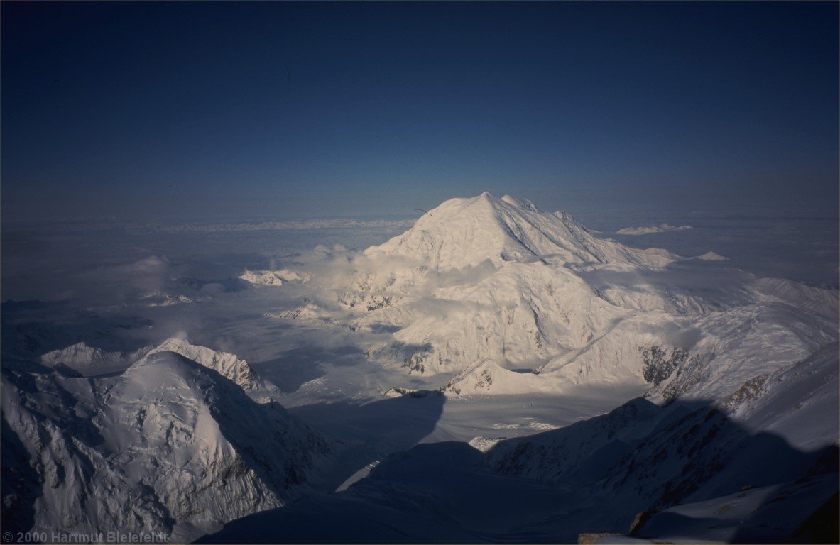 At eight in the morning. In front of Mount Foraker, Kahiltna Glacier is writhing through the mountains