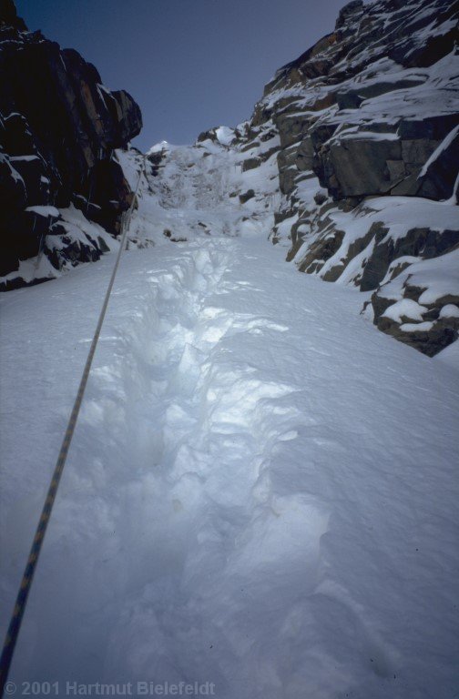 The gully is deep snow-covered, the rope frozen.